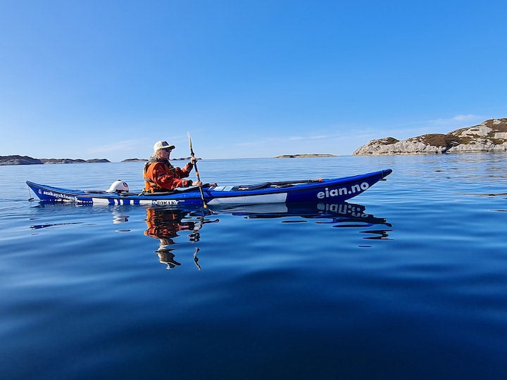 woman in a sea kayak, kayaking on the ocean