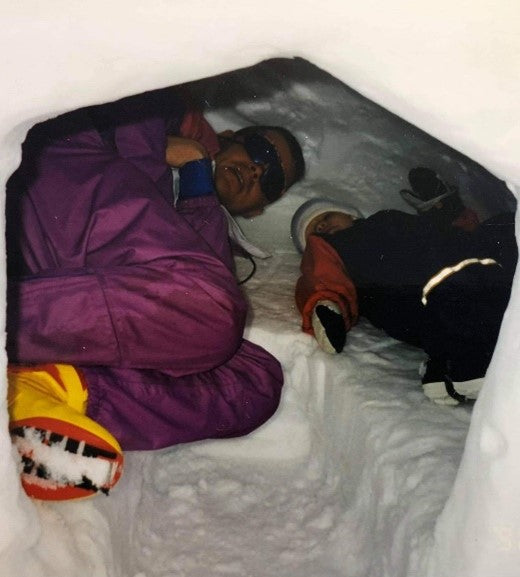 Emma as a child and her Dad in a snow fort