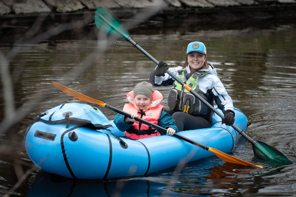 Emma and Astrid paddling in Big Blue, their packraft