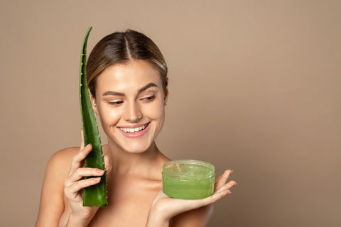 Frau hält Aloe Vera Gel und Blatt