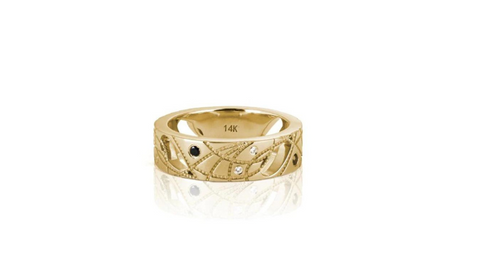 a 6mm wide shiny yellow gold band with engraved swirls, cutouts and embedded black, champagne, and white diamonds