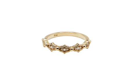 A yellow gold band with a playful shape and embedded diamonds