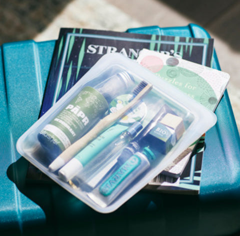 Stasher Quart bag packed with travel toiletries