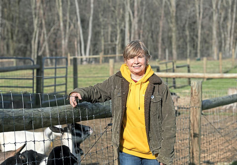 Woman standing with goats