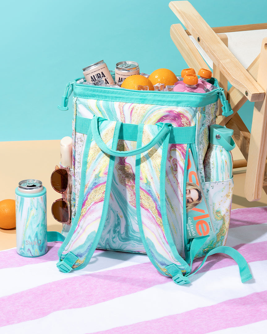 Wanderlust Packi Backpack Cooler and Drinkware with snacks and drinks on beach