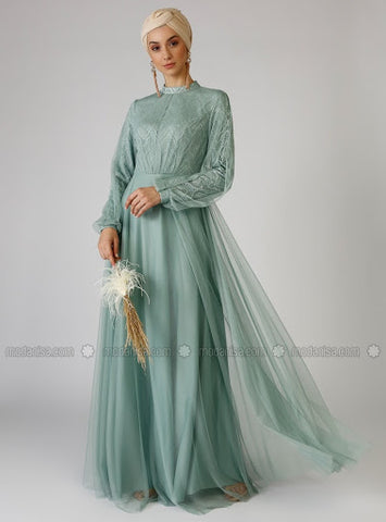 Gorgeous women's dress in mint exemplifying well a high neckline design.