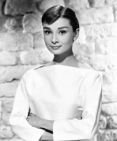 Audrey Hepburn is depicted in her iconic boatneck white dress, that she made super populate in 1950, especially after her main role in Sabrina.