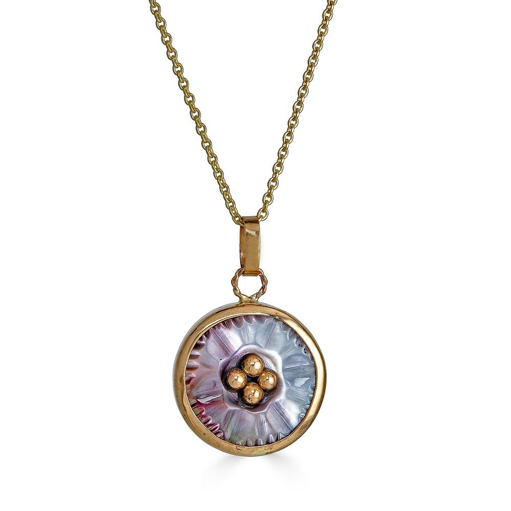 Gold Button Beauty Necklaces Ronnie Taubenfeld is a limited edition mother of pearl button handset in 14k yellow gold suspended from a 14k gold cable chain.