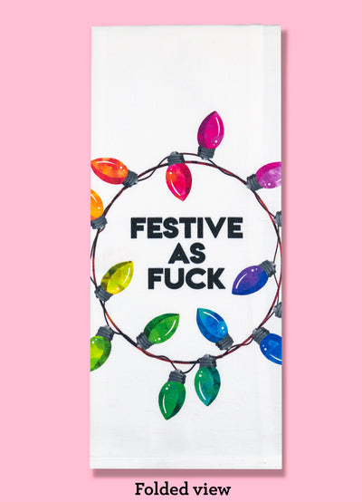 The Festive As Fuck kitchen towel, shown folded into thirds