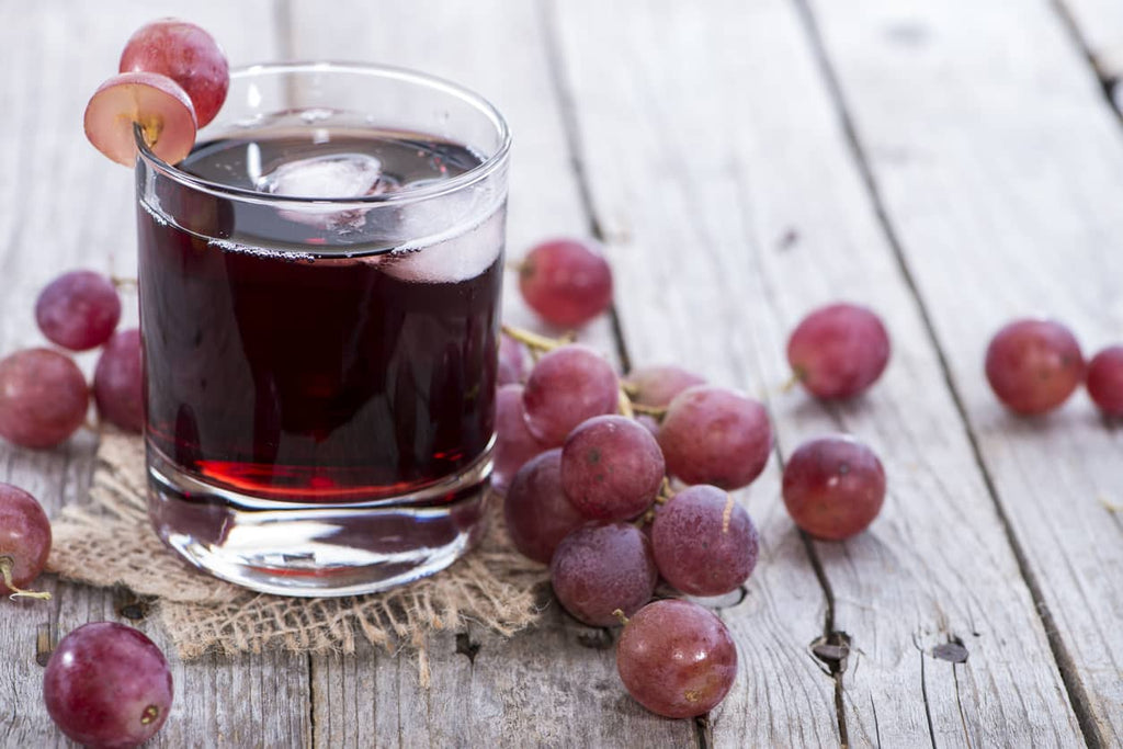 glass of grape juice with grapes