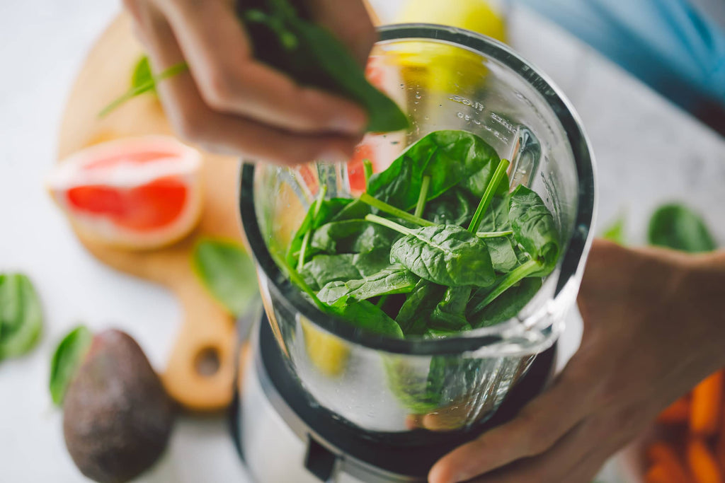 green leaves in a glass for juicing