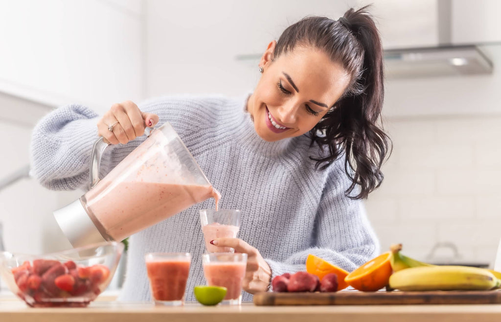 pouring smoothie from blender to glass