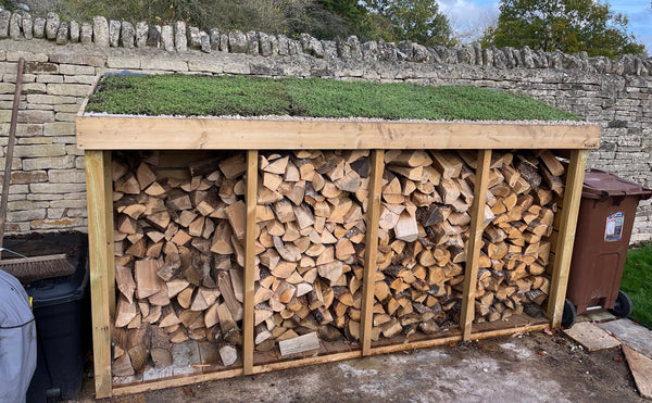 Log store with a living green roof planter, filled with sedum plants. Perfect to store your firewood outside