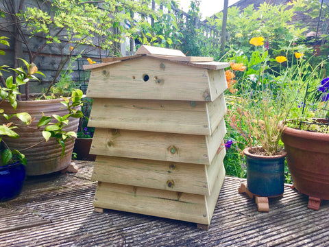 Beehive style compost bin in a garden setting