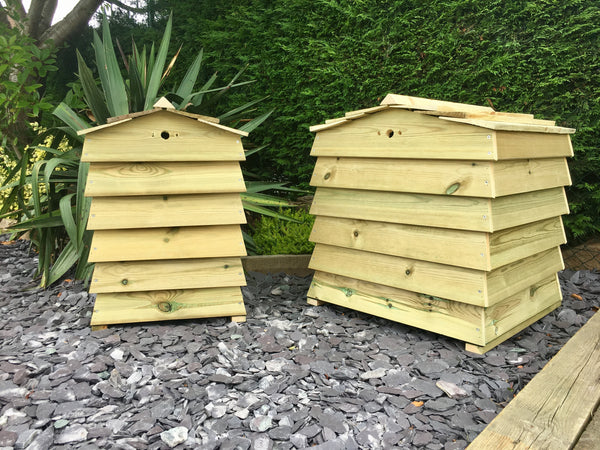 Beehive style compost bins or composters in a garden