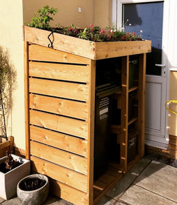 Wheelie bin store with recycling box shelves and living roof planting area 