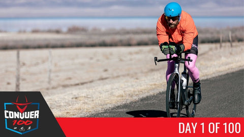 James "The Iron Cowboy" Lawrence wearing blacktop+ kinesiology tape while riding a bicycle.