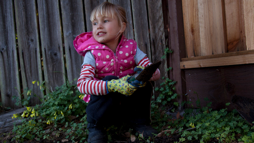 Child digging in garden