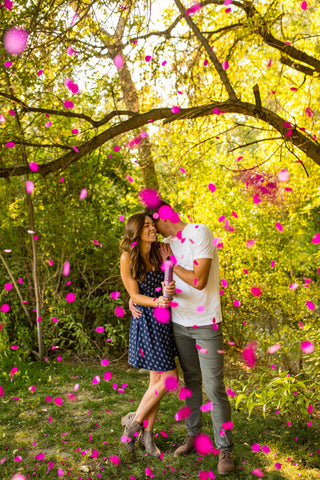 gender reveal for couple using pink confetti gender reveal cannons