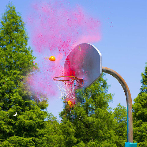 Pink Powder Basketball Gender Reveal breaking open on basketball net and backboard