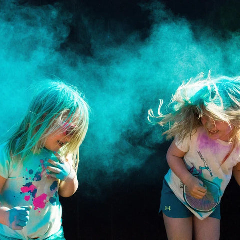 Children with blue powder for gender reveal