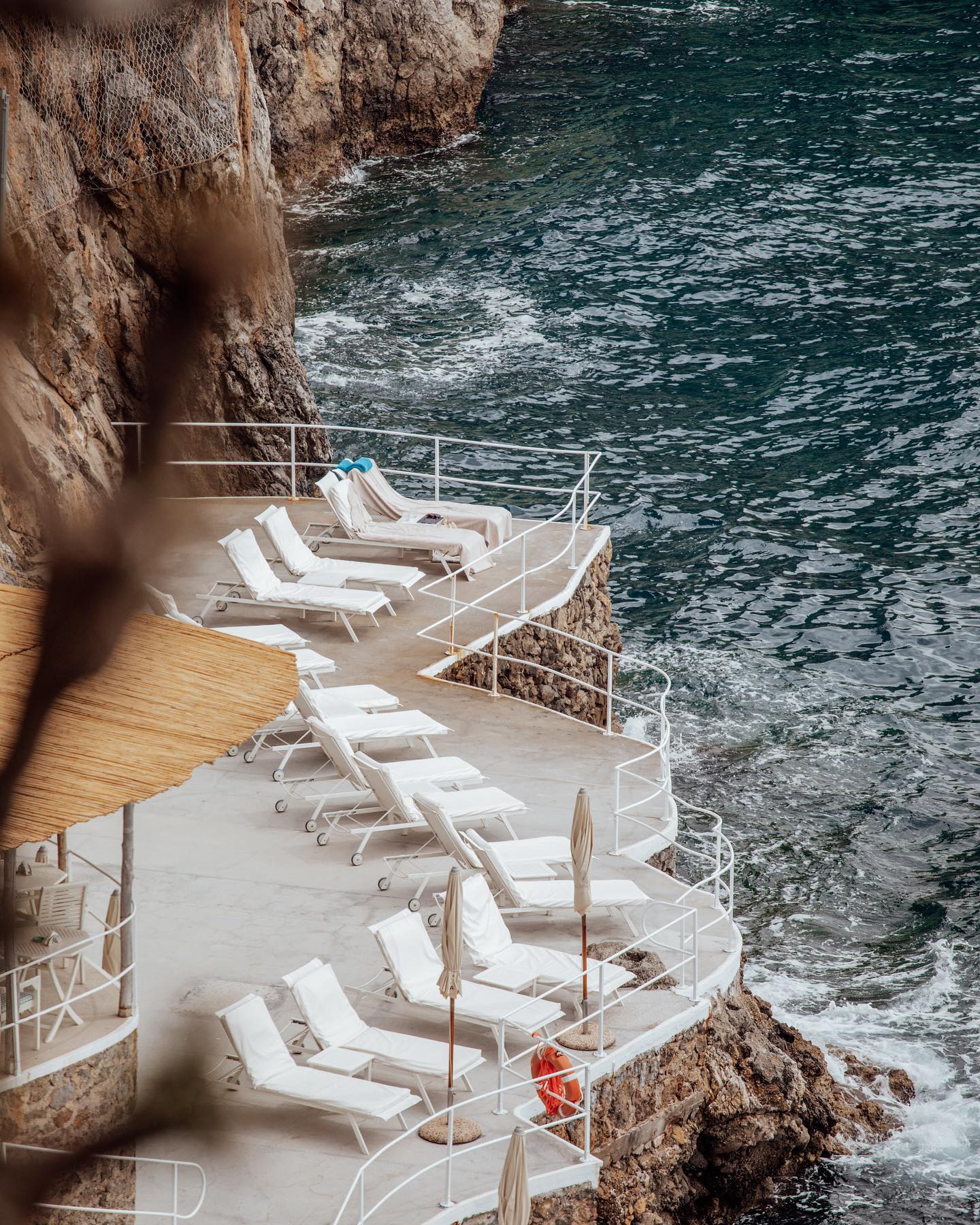 Sun beds on a cliff setting at the Hotel Santa Caterina to contemplate the Amalfi Coast