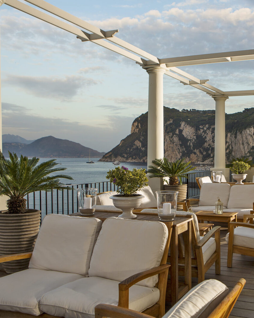 Luxurious yet inviting terrace at the J.K Place Hotel with a view over the ocean and mountains