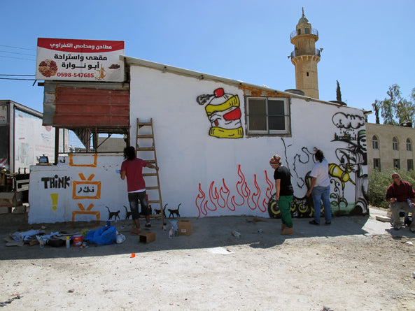 Painting a wall in Bethlehem on the roadtrip 