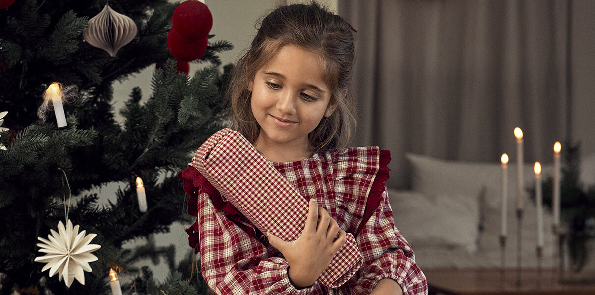 Girl opening Christmas gift