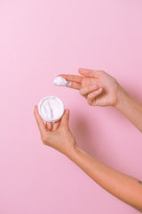 face cream from jar on fingers