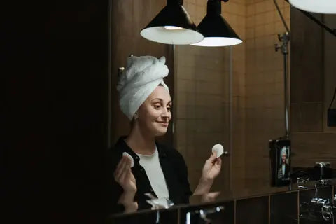woman in the bathroom washing her face