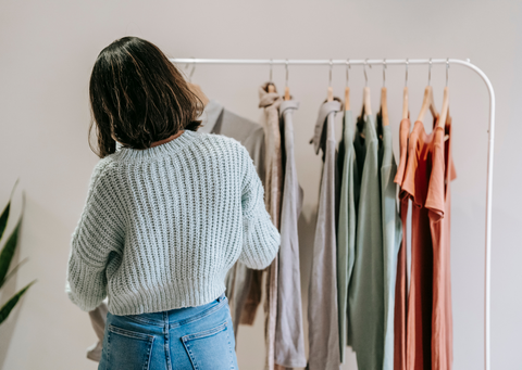 Woman choosing from a minimalist wardrobe