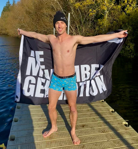 Ollie, one of the models sporting our blue Mara trunks, a Movember flag and beanie