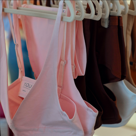 Light Pink bralette and Light Pink bikini bottoms shown on rail of Y.O.U Underwear