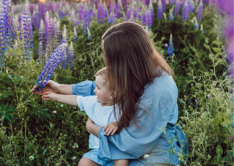 Mum and baby looking at flowers