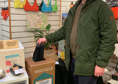 Man puts underwear into the recycling box