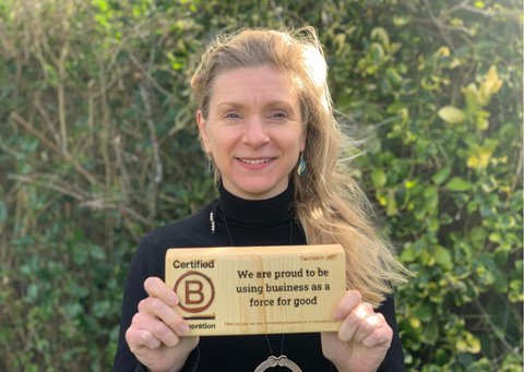 our CEO Sarah holding our wooden b corp block