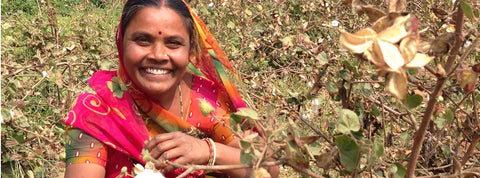 A smiling Indian woman in the cotton fields