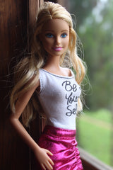 Barbie doll wearing a 'Be Yourself' slogan t-shirt