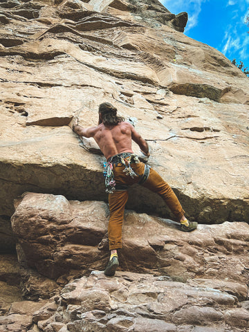 Josh Tyler Savage Gentleman Rock Climbing on wall reaching