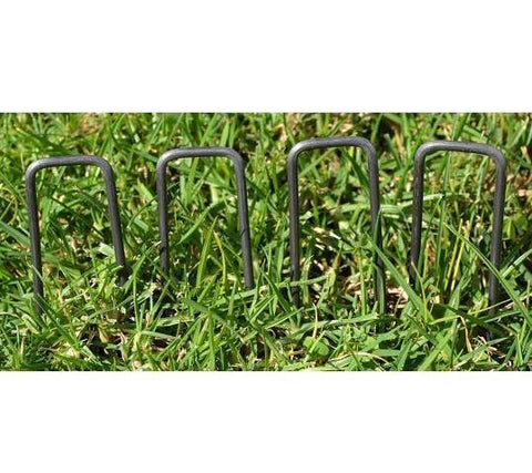 9-inch Square Top Landscape Staples being used in green grass