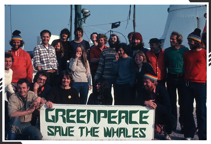 Greenpeace members posing with Save the Whales banner