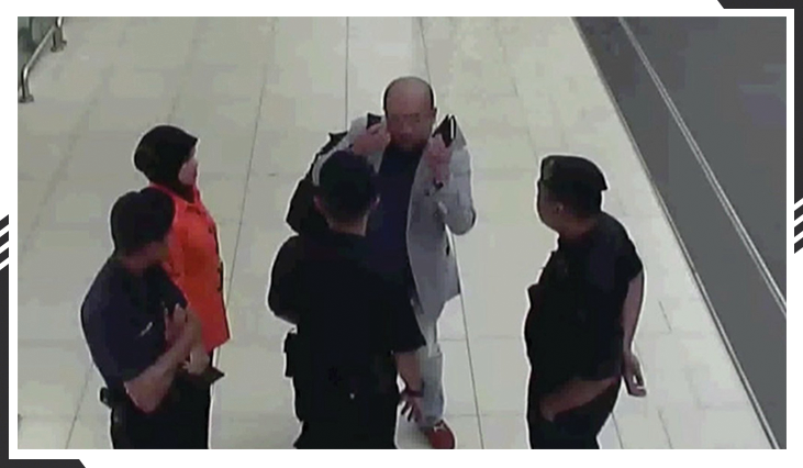 Kim Jong Nam gesturing towards his face as he talks to security officials after being attacked in the Kuala Lumpur airport