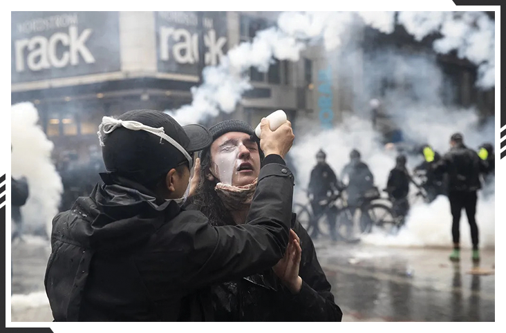 A protester in Seattle attempts first aid, 2020