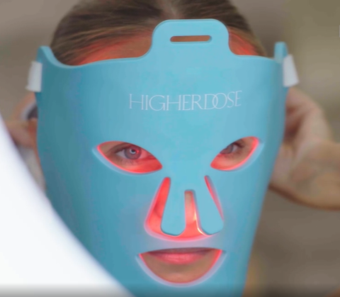 Woman wearing a HigherDOSE Red Light Face Mask