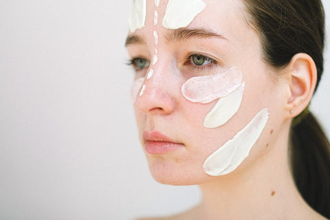 Women with cosmetic cream on her face
