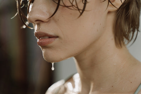 A close-up shot of a woman sweating