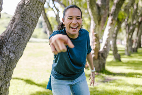 Energetic and happy woman pointing a finger at the camera
