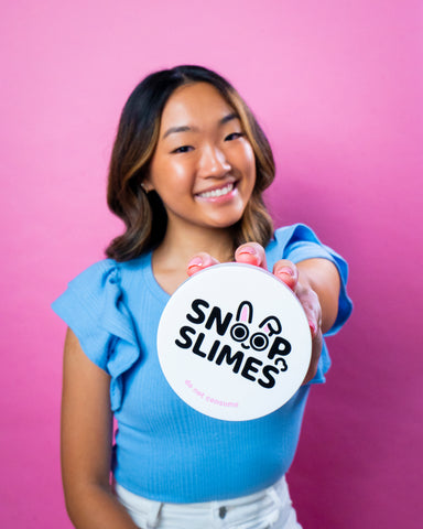 Snoopslimes Founder Jungmin Kang holding her a labeled Snoopslimes container!