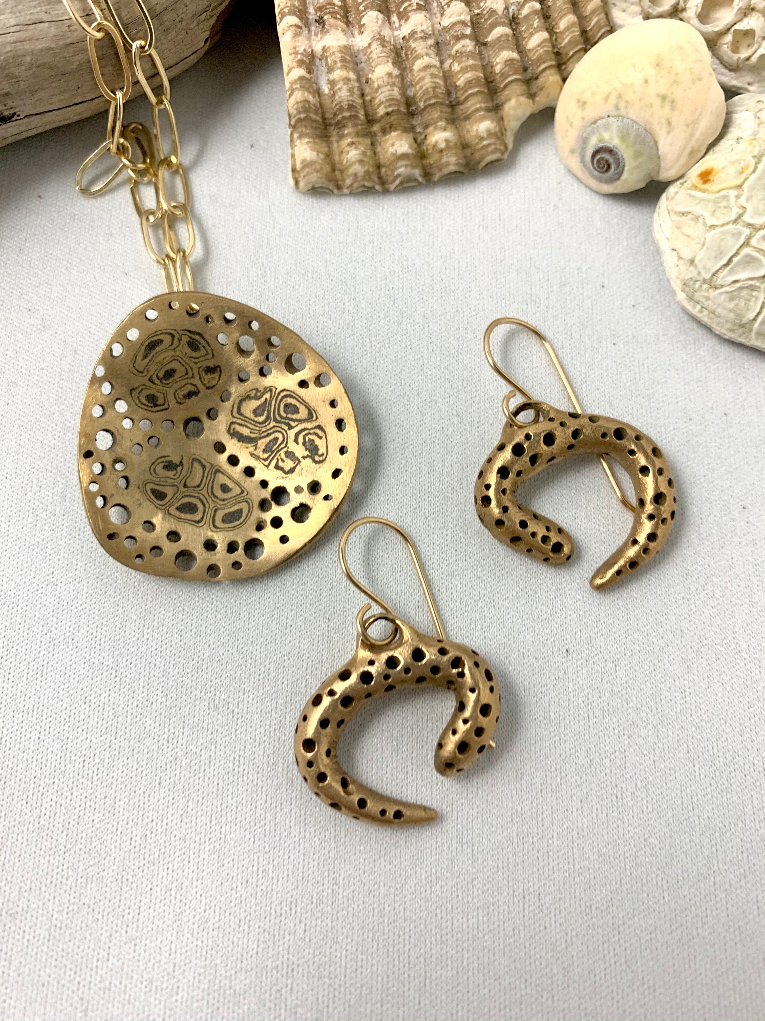 Bronze earrings paired with art jewelry necklace